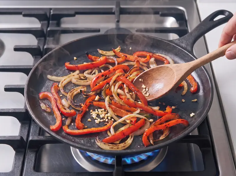 Bell pepper and onion strips softened with garlic for the chicken quesadilla