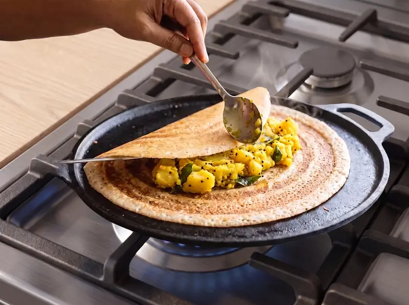 Spiced potato masala spooned onto a crisp dosa before folding
