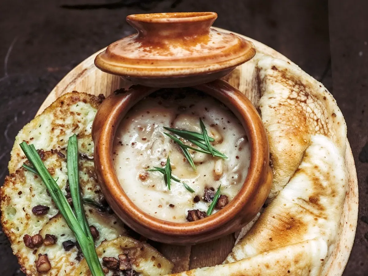 Machanka (Belarusian Pork Sauce with Pancakes) with pork belly, sour cream and sausages — Belarus recipe