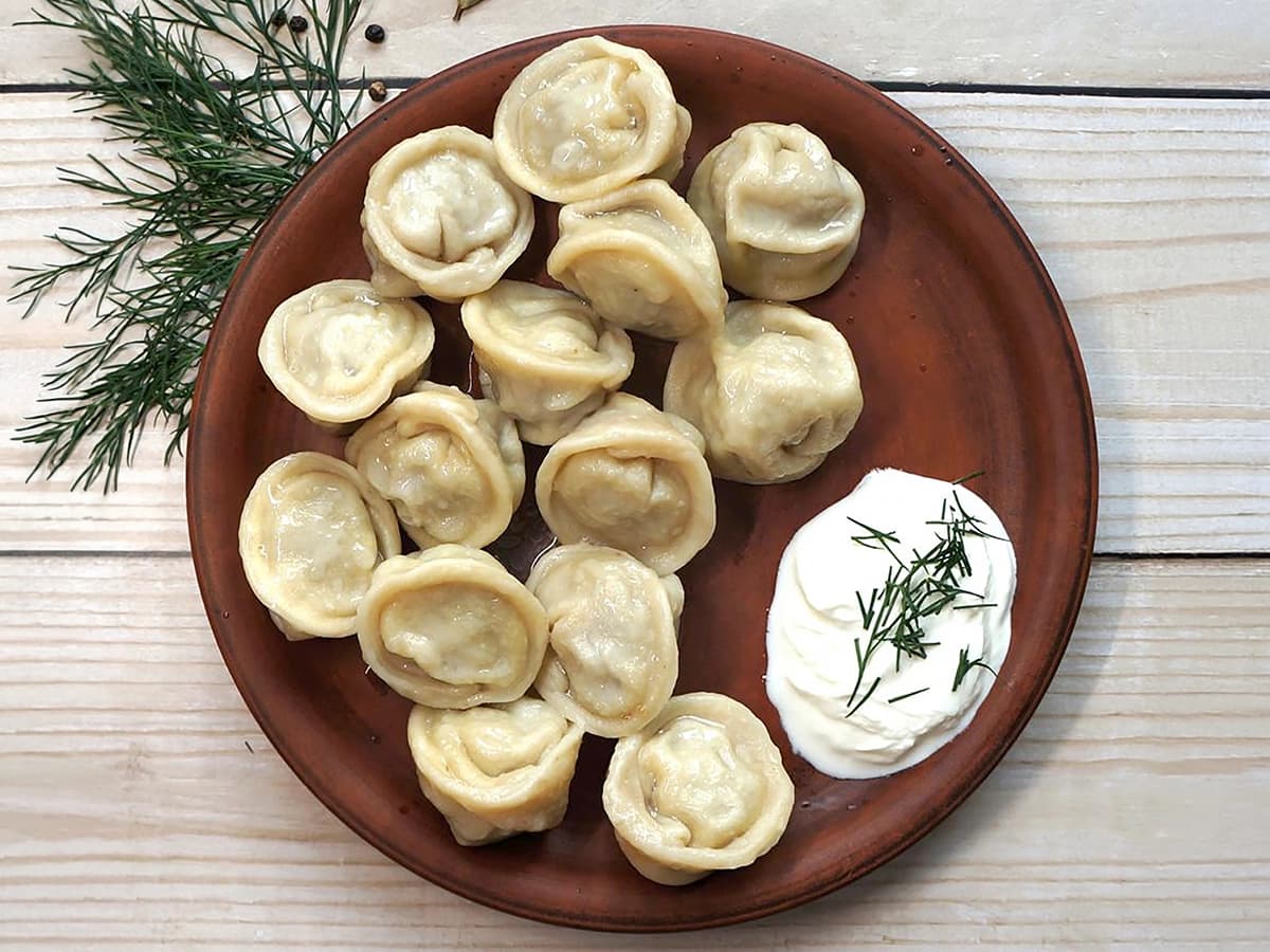 Pelmeni (Russian Meat Dumplings) with wheat flour, minced meat and onions — Russia recipe
