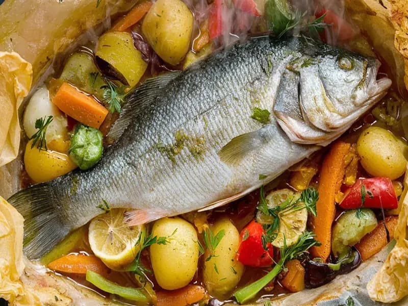 Sea Bass Baked in Paper with sea bass, lemon and tomato — France recipe