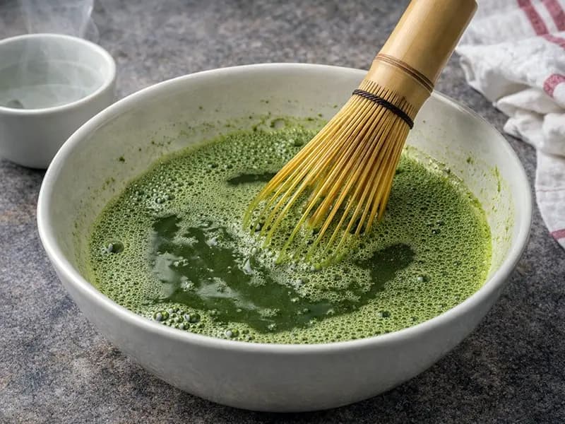 Matcha whisked with hot water to a lump-free soak for the matchamisu