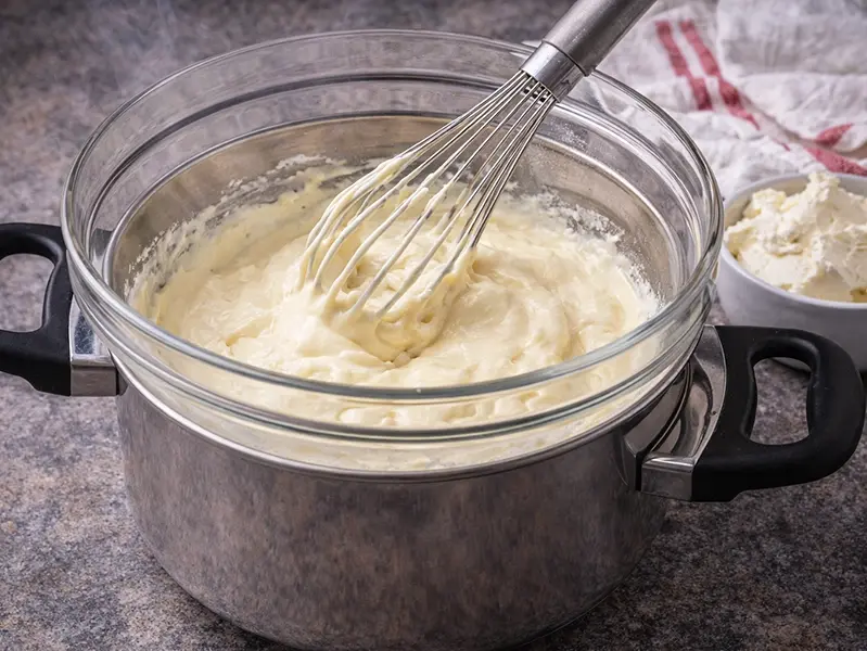Egg yolks and sugar whisked pale and ribbony over a water bath for the cream