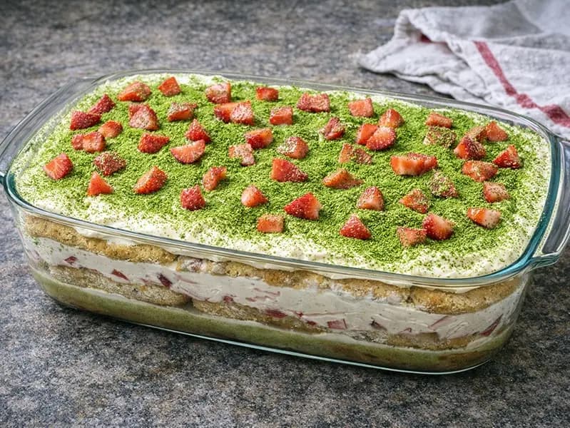 Chilled strawberry matchamisu topped with fresh berries and dusted matcha