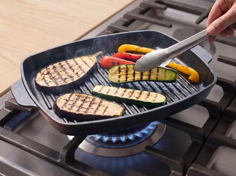 Vegetable planks on a ridged grill pan with clear char marks for verdure alla griglia
